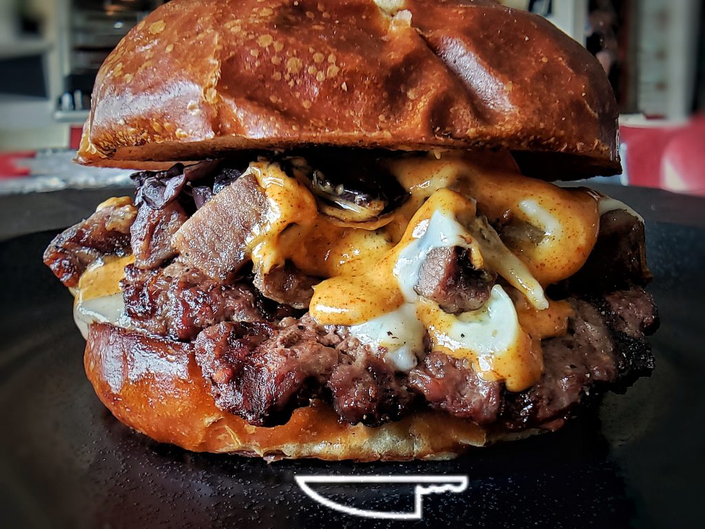 Chicago Prime Rib Burger with rosemary prime rib, Swiss and Pepper Jack cheese on pretzel bun