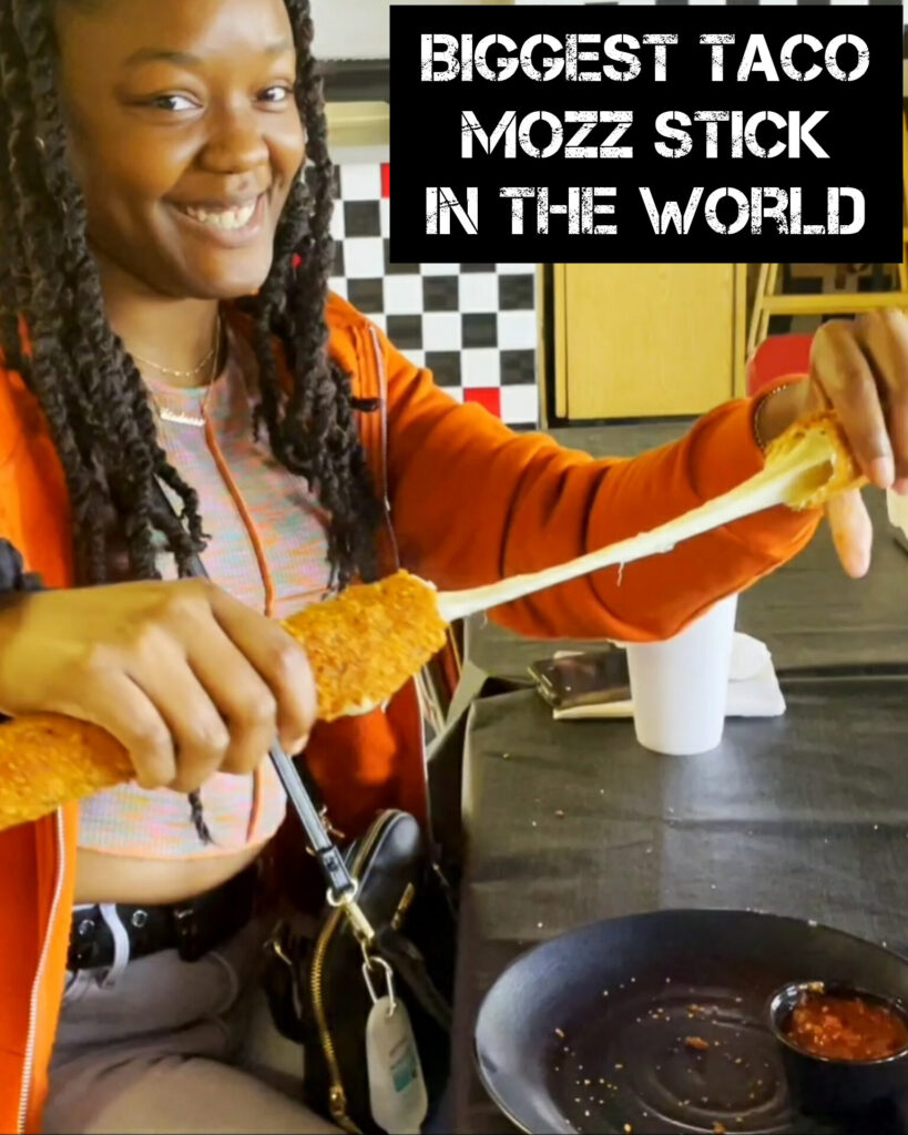 Customer doing an epic cheesepull with Frato's famous mozzarella sticks in Schaumburg