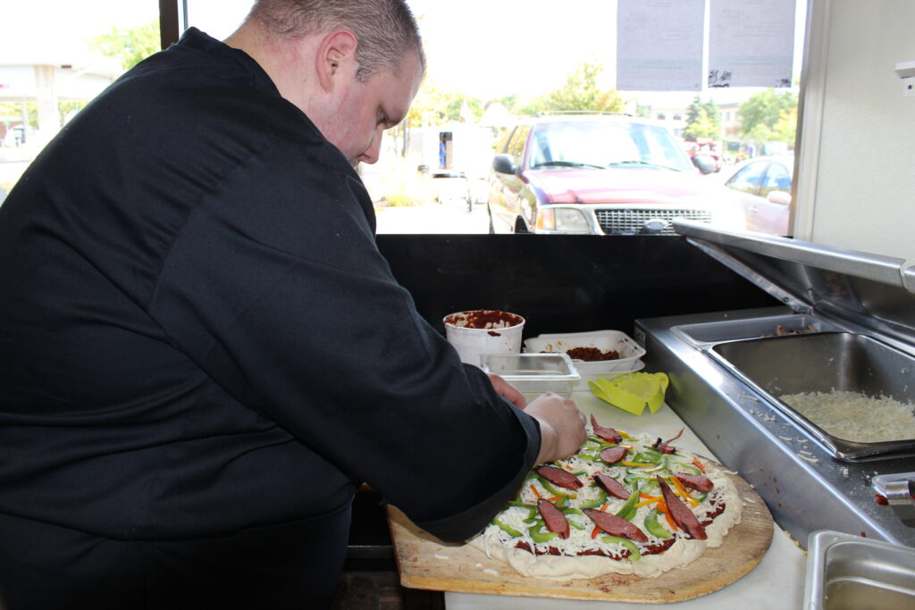 Chef making pizza from scratch at Frato's