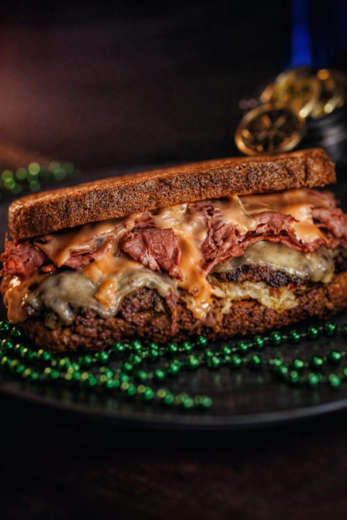 Reuben Burger with scratch-made braised corned beef brisket, bacon sauerkraut, Swiss cheese, and Thousand Island on marble rye
