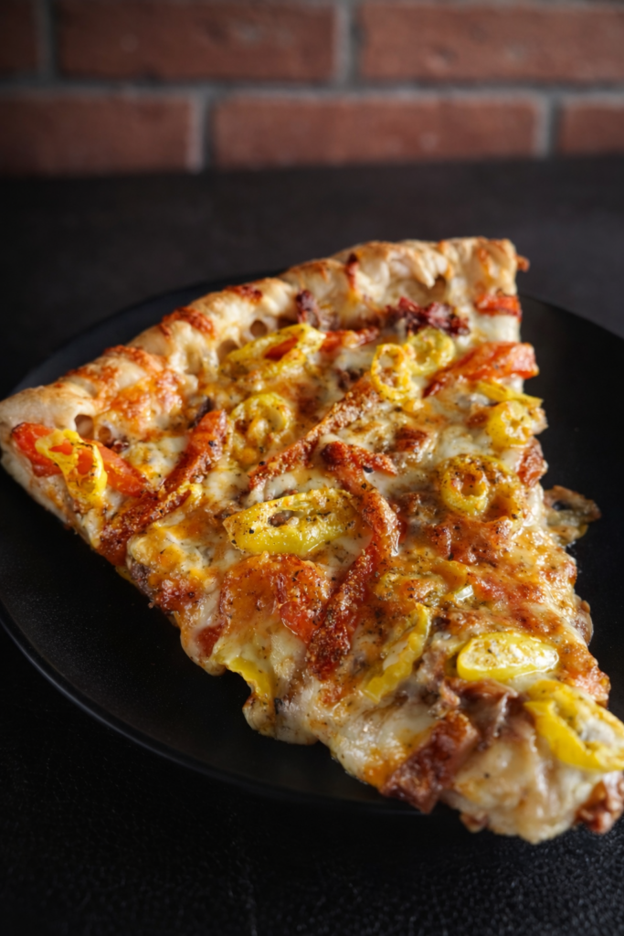 Close-up of Italian Beef Smash Pizza showing melted cheese and scratch-roasted Italian beef