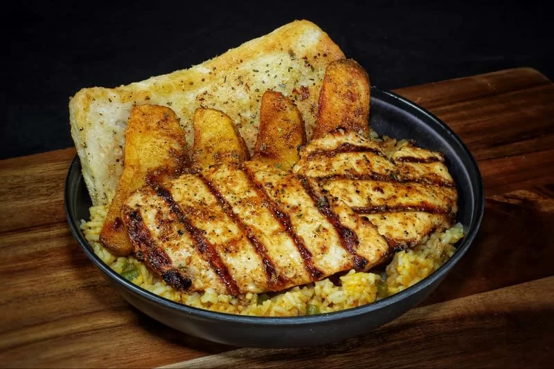 Frato’s Southwest rice bowl with grilled chicken breast, potato wedges and Texas-style garlic bread