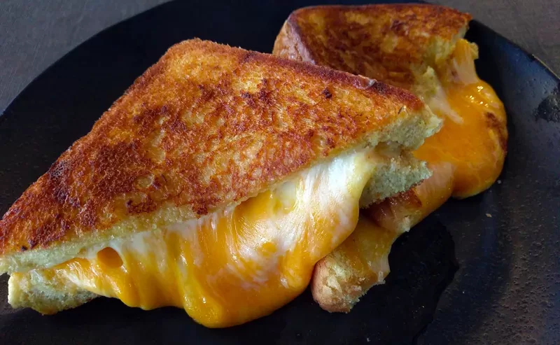 Frato’s grilled cheese on Texas toast cut in half, with melted mozzarella, American and cheddar