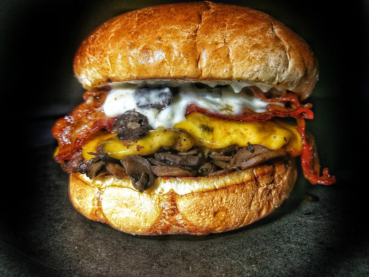 Frato’s Whiskey Burger with whiskey-glazed bacon, cheddar and red wine marinated mushrooms
